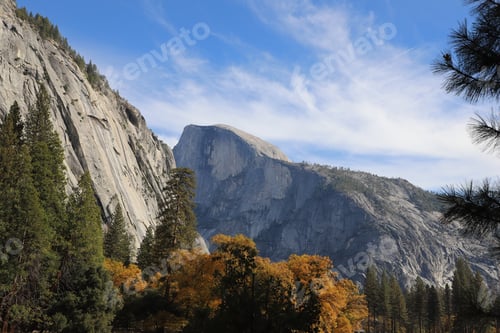 Preview: High mountains with rocky top rising up to the blue sky in autumn season