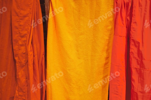 Preview: Closeup shot of Buddhist monks orange and yellow robes hung up to dry in the sun
