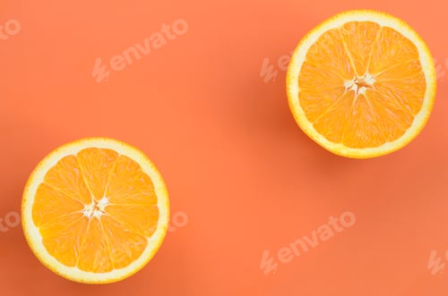 Preview: Top view of a several orange fruit slices on bright background in orange color