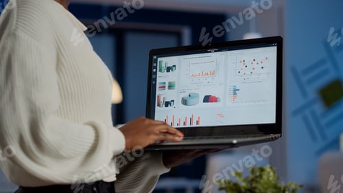 Preview: Close up of dark skin woman typing on laptop standing in start up office