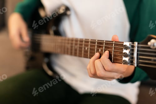Preview: Closeup Of Guy's Hands Playing Chords On Electric Guitar Indoor