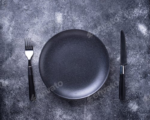 Preview: Empty plate and silverware on concrete table