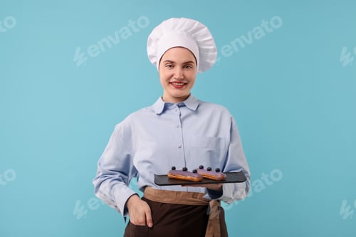 Preview: Confectioner with delicious eclairs on light blue background