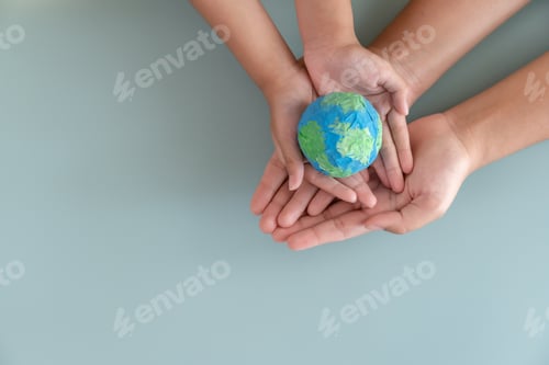 Preview: Hands holding earth paper and water paint. Concept of sustainability environment protection