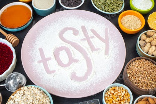Preview: top view tasty written flour with nuts seeds cereals raisins and jelly on dark background cake