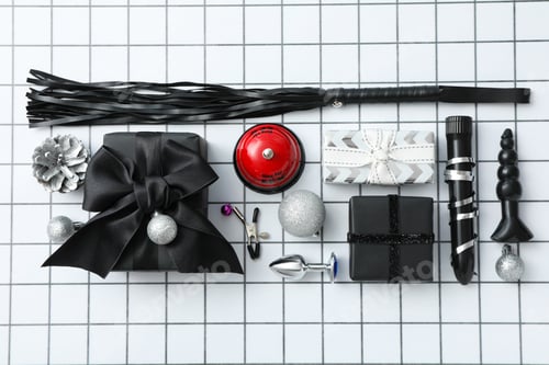 Preview: Sex toys with Christmas gifts on the background.