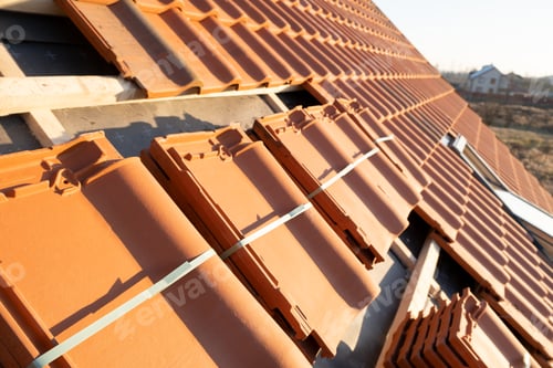 Preview: Stacks of yellow ceramic roofing tiles for covering residential building roof under construction