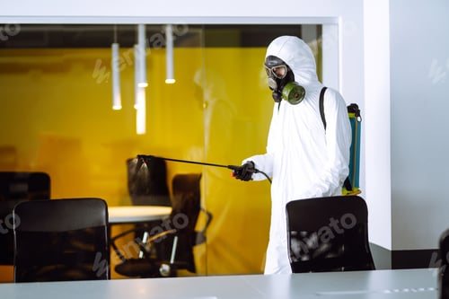 Preview: Disinfecting of office to prevent COVID-19, Man in protective hazmat suit with spray chemicals.