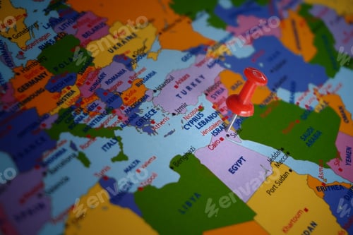 Preview: Push pin pointing at Israel on world map.