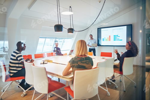 Preview: Manager talking with staff during a meeting together in an office