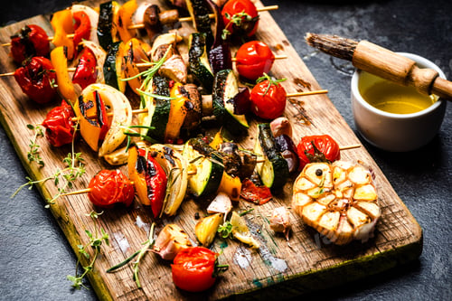 Preview: Serving Grilled BBQ Vegetables Skewers with Fresh Herbs, Marinate and Spices on Wooden Board