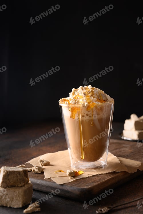 Preview: Tasty coffee latte with halva in glass cup.