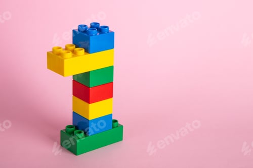 Preview: Color plastic building blocks on pink background