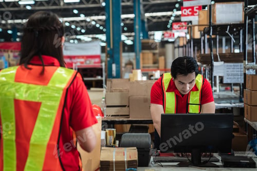 Preview: Warehouse worker checking details stock product and scanning a barcode on box package.
