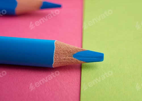 Preview: Sharpened blue pencil on a pink background