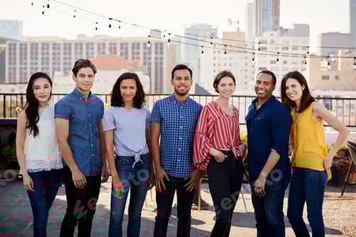 Preview: Portrait Of Friends Gathered On Rooftop Terrace For Party With City Skyline In Background