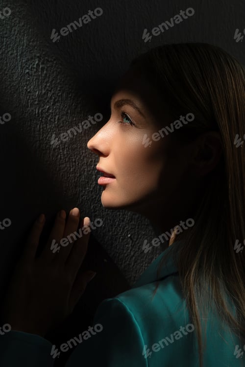 Preview: Contemplative Woman Posing in Shadowed Room