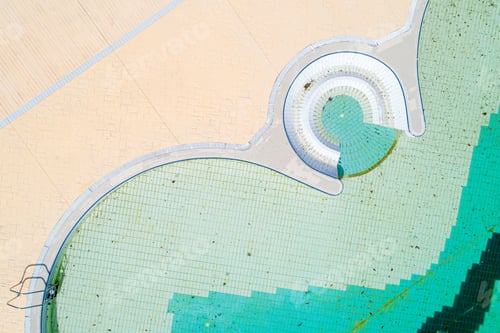 Preview: zenithal aerial view with drone of a swimming pool with dirty water after the winter