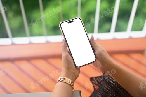 Preview: Cropped shot of woman hands holding smartphone while sitting at office terrace