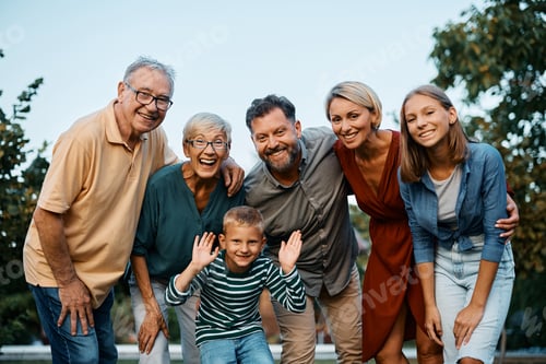 Preview: Cheerful multigeneration family in nature looking at camera.