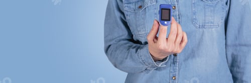 Preview: Woman self testing for blood oxygen levels from pulse oximeter