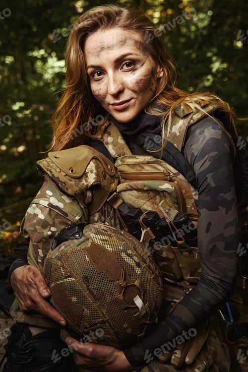 Preview: Smiling female person in uniform holding military helmet
