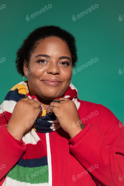 Preview: Stylish plus size woman showcasing trendy autumn fashion in vibrant studio setting