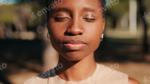 Preview: A girl with her eyes closed against the background of nature