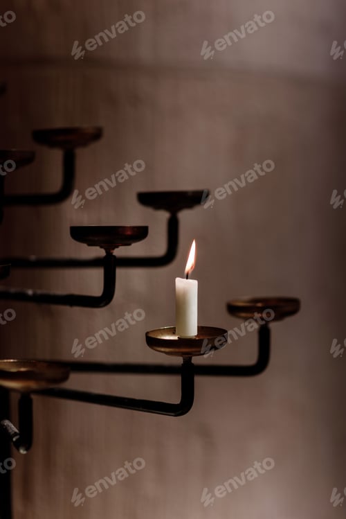 Preview: candle burns in the rustic candlestick. candle in church