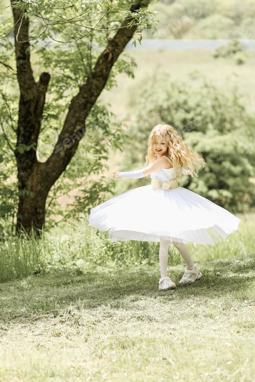 Preview: Little blonde
girl in a fluffy white dress