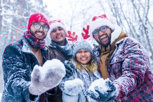 Preview: four people taking selfie shot outdoors at new year holidays