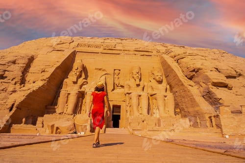 Preview: A young tourist girl in red dress walking towards the Abu Simbel Temple