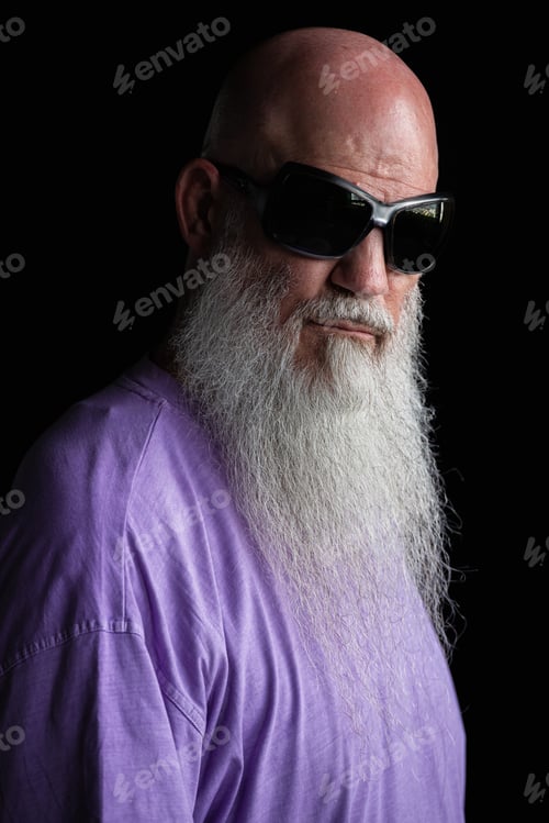 Preview: Portrait of man with long gray beard wearing purple t-shirt and sunglasses close-up shot