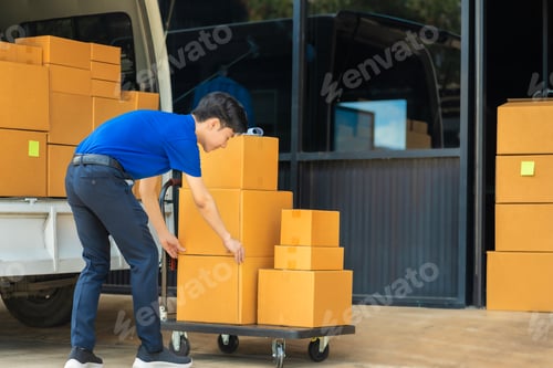 Preview: Asian delivery man work in truck for checking the product in the truck, concept ecommerce.