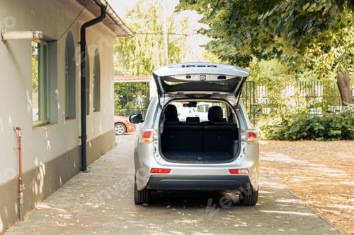 Preview: No people in driveway with car trunk open
