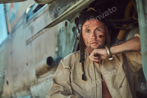 Preview: Mechanic in uniform carries out maintenance of an old military bomber in an open-air museum.