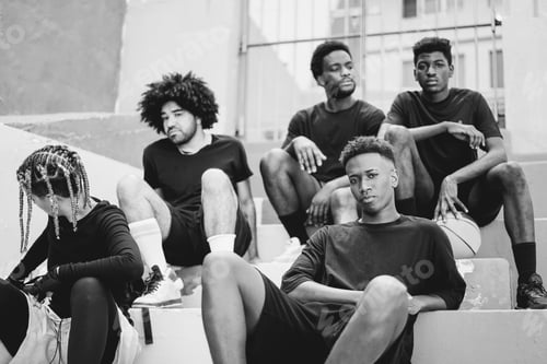 Preview: Group of young african people resting after basketball match