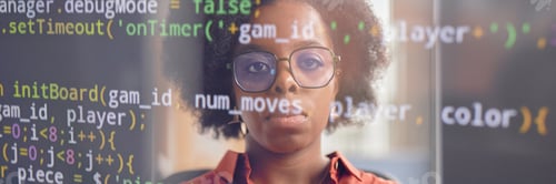 Preview: Reflection of Female Programmers Face in Computer Screen with Code