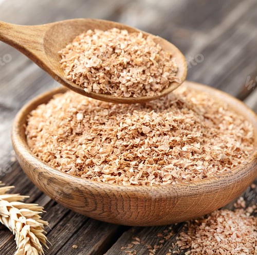 Wooden Bowl Filled with Bran and Spoon