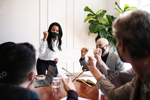 Preview: Business people wearing masks in coronavirus meeting, the new normal