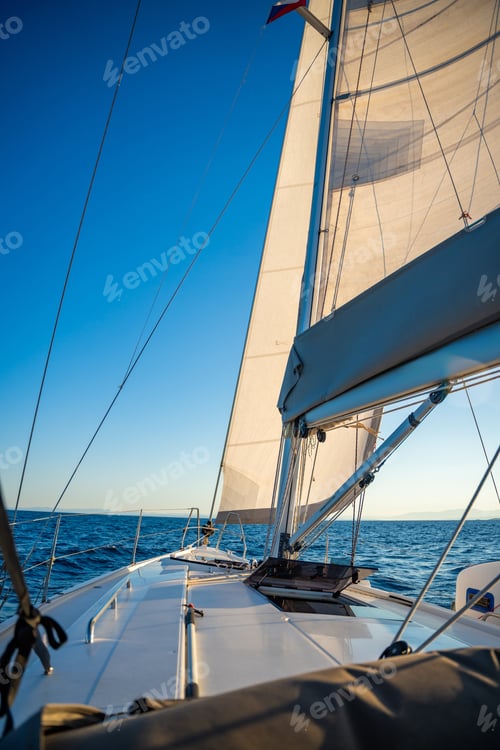 Preview: Yacht sailing in an open sea. Close-up view of the deck, mast and sails. Yachting concept