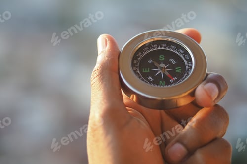 Preview: Exploring nature with a compass in hand during daytime