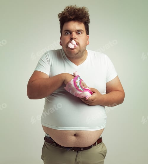 Preview: Must have more marshmallows. Shot of an overweight man with marshmallows shoved in his mouth.