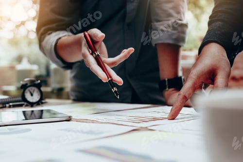 Preview: Two businessmen working with a digital tablet and make writing report on notebook.