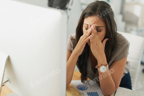 Preview: Shot of an overwhelmed businesswoman sitting by her computer in the office