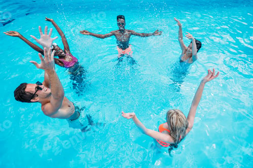 Preview: Group of young happy multiethnic people having fun together in swimming pool