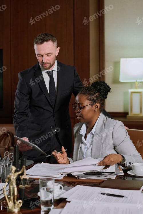 Preview: Man presenting document to colleague