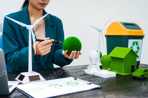 Preview: An Asian businesswoman sits at her desk, discussing clean energy solutions their impact on homes
