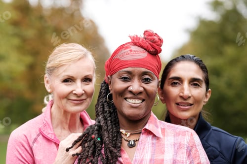 Preview: Three happy senior friends women are looking at camera outdoors.