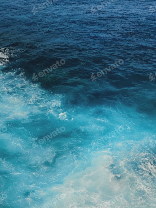 Preview: Aerial top view of waving shiny seawater in two different colors